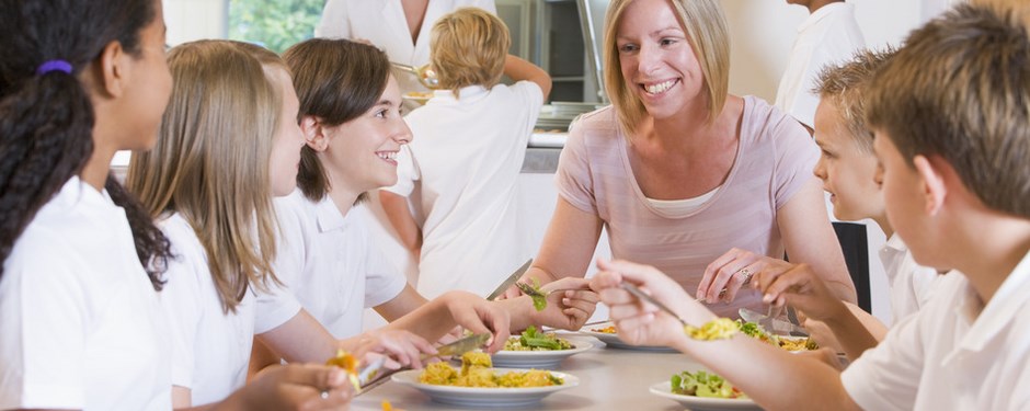 teacher-and-schoolchildren-enjoying-their-lunch-in-a-school-cafeteria-s.jpg